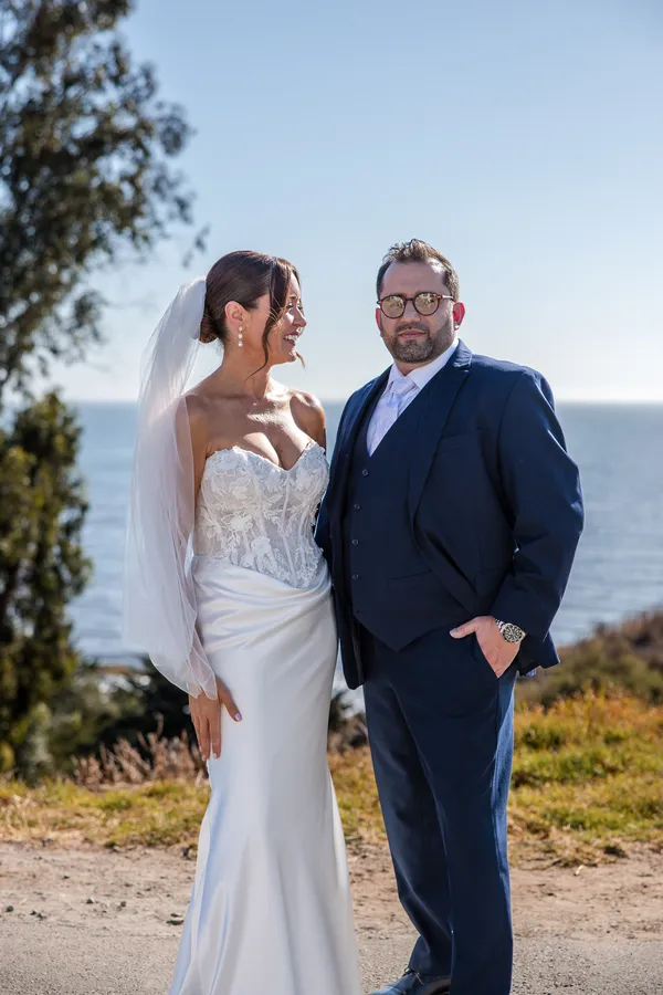 Bride and groom on a coastal bluff