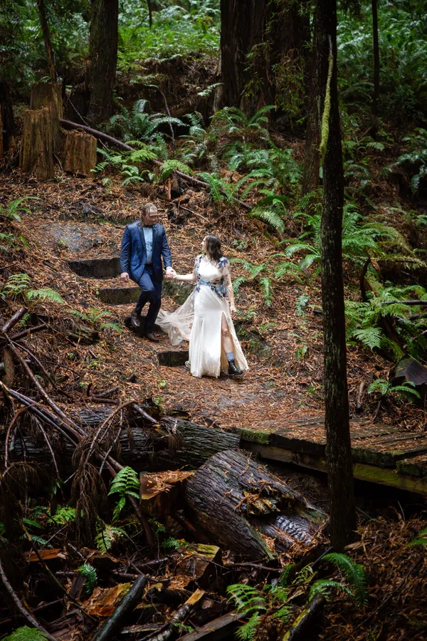 Couple descending a forest trail